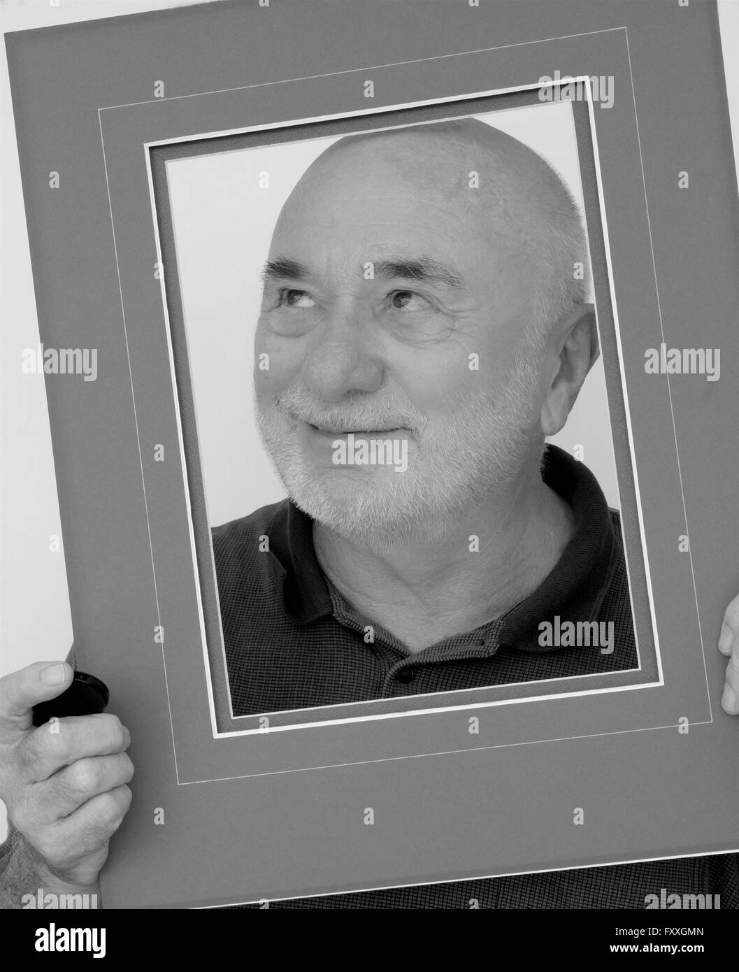 A cranky old man framed in black and white. Stock Photo