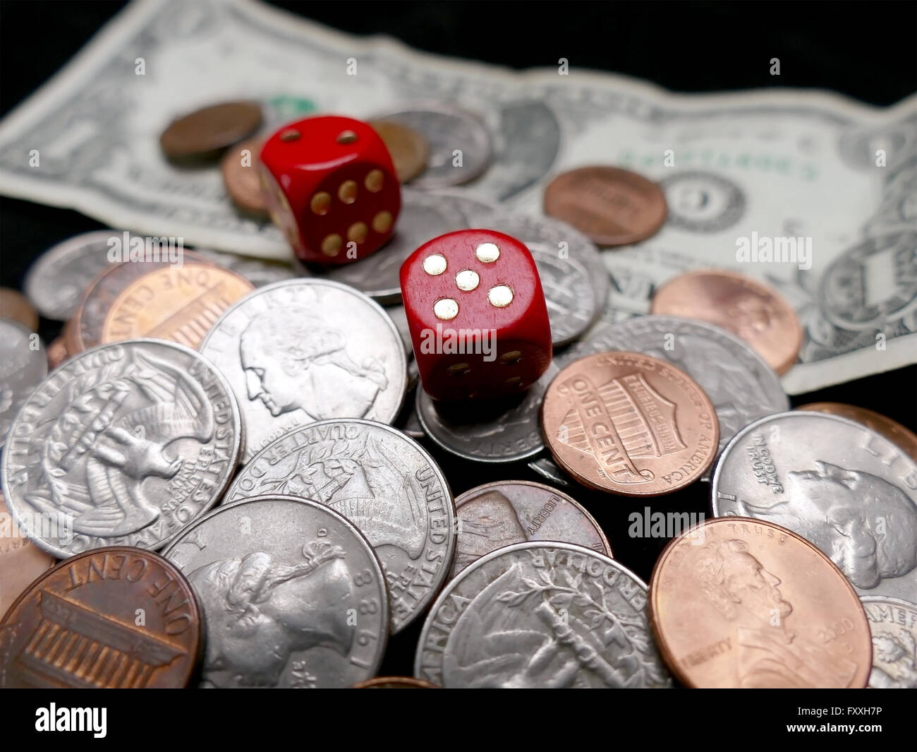 Dice on paper money and coins. Gambling concept Stock Photo