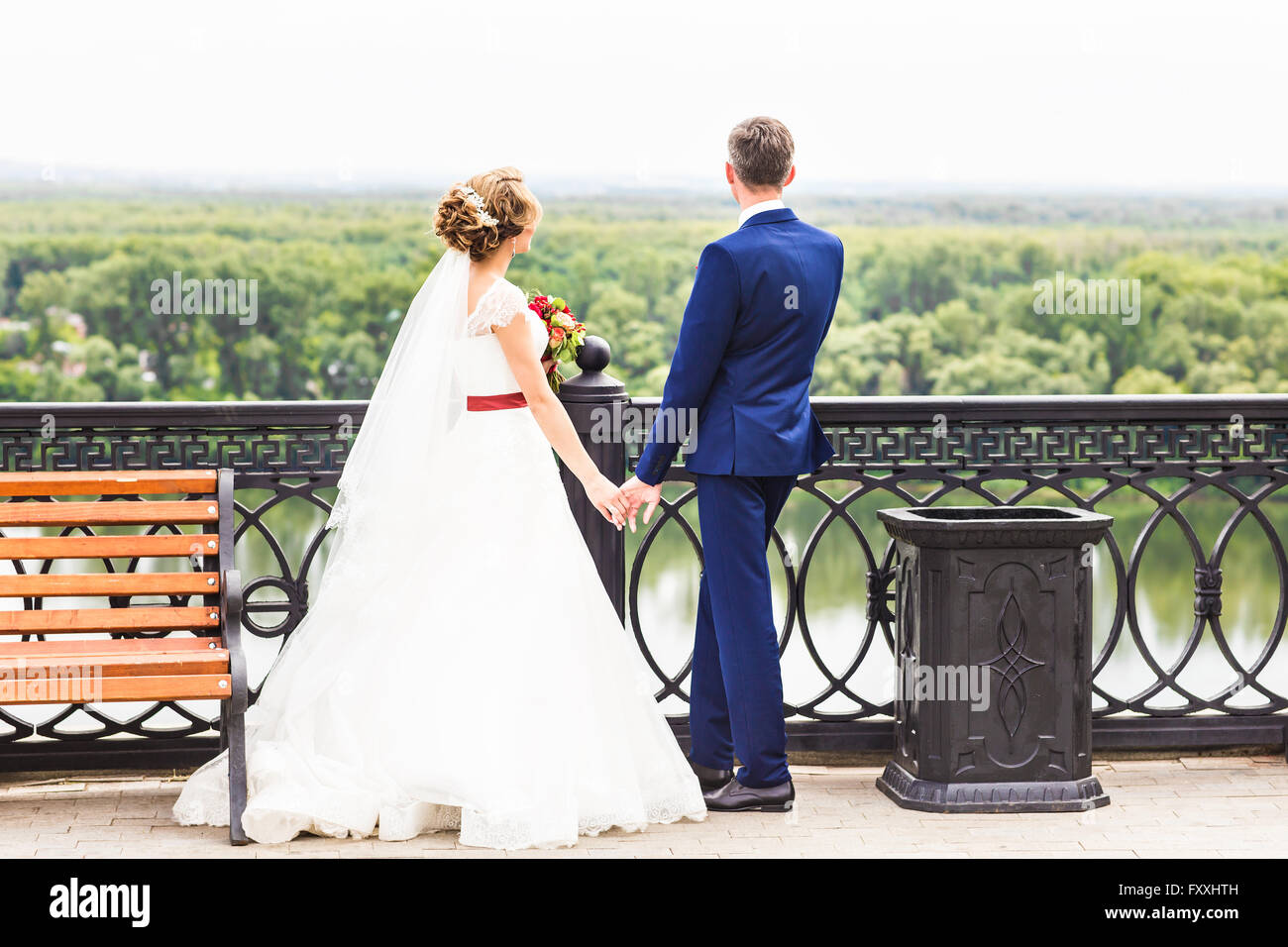 wedding theme, holding hands newlyweds Stock Photo - Alamy