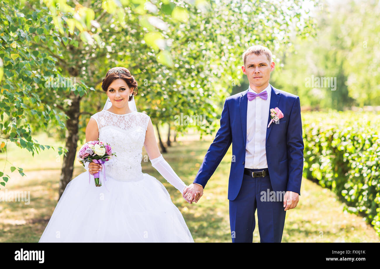 wedding theme, holding hands newlyweds Stock Photo - Alamy