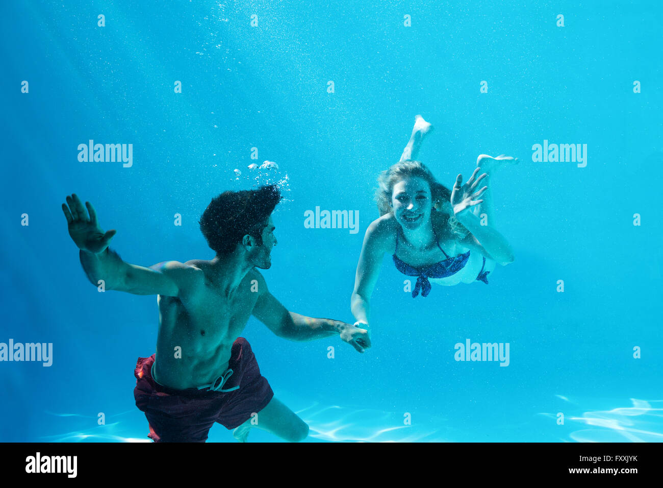 Happy couple swimming underwater Stock Photo Alamy