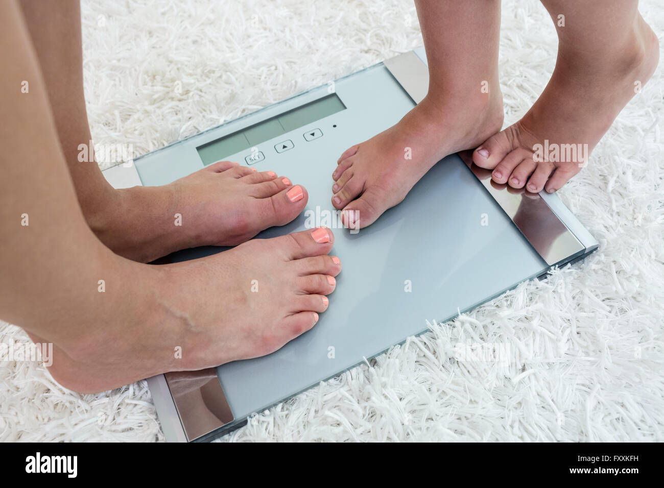 Woman hugging weight scale hi-res stock photography and images - Alamy