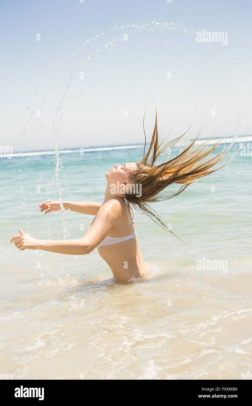 Blonde woman tossing her wet hair Stock Photo