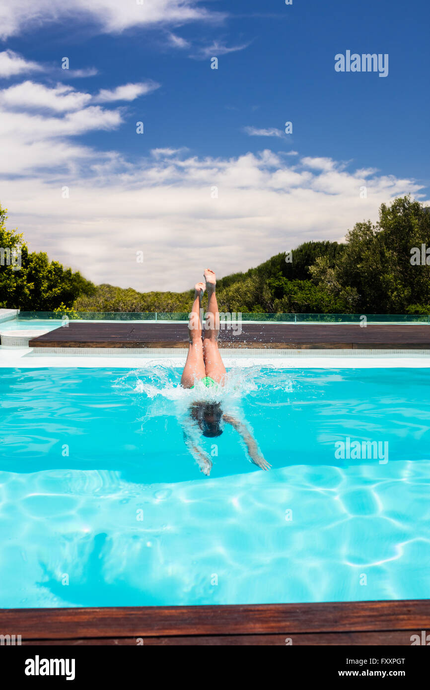 Woman diving into swimming pool Stock Photo - Alamy