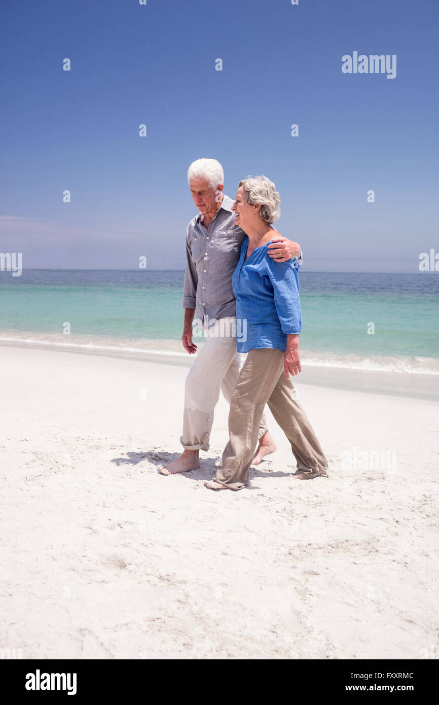 Senior couple walking on the beach Stock Photo - Alamy
