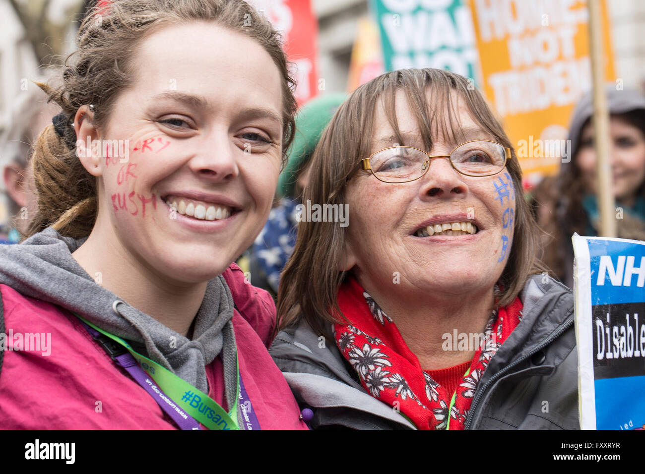 A young nurse marching against proposed cuts to nursing education marches with her mother at the anti-austerity march. Stock Photo