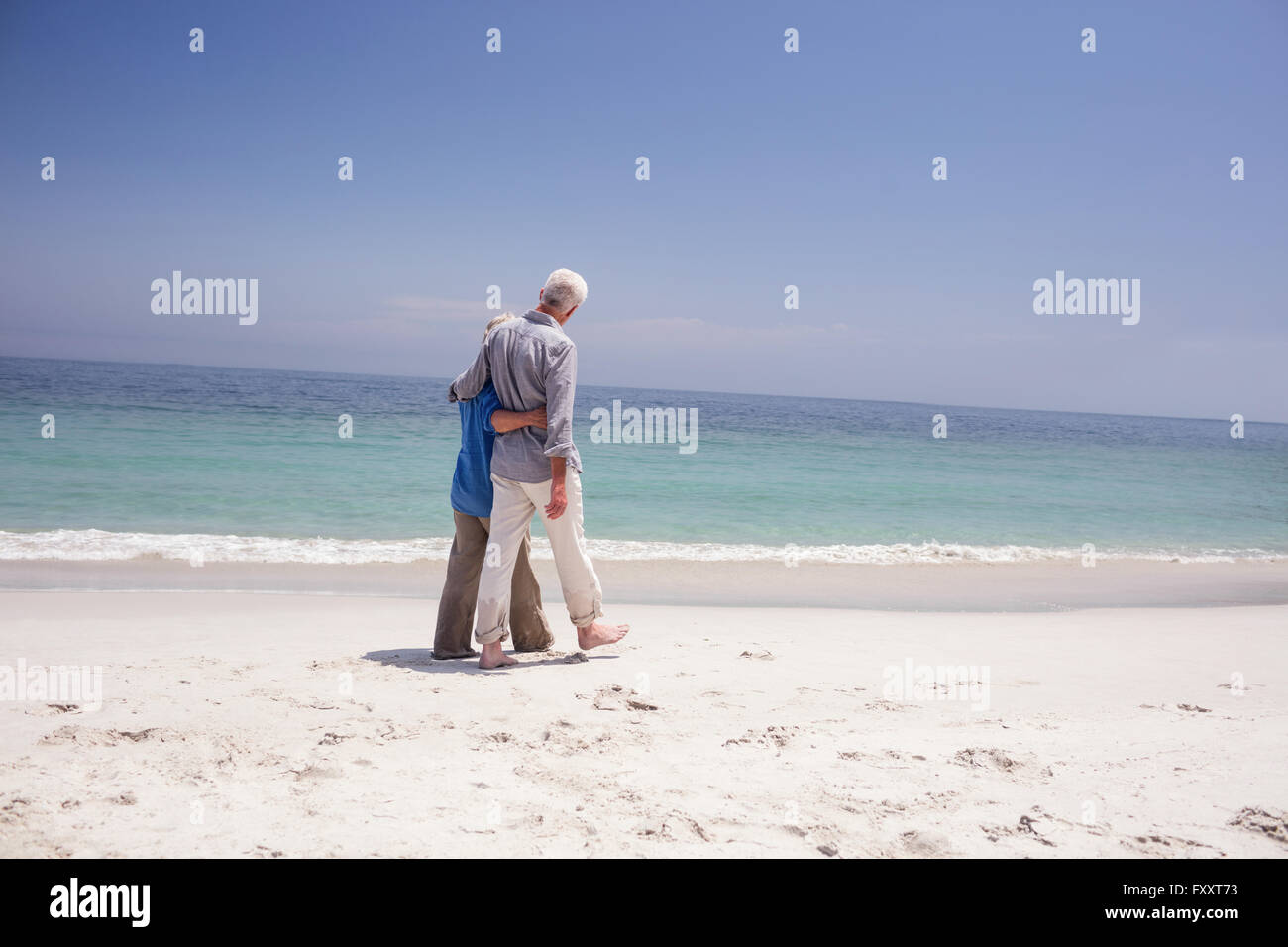 Senior couple walking on the beach Stock Photo - Alamy