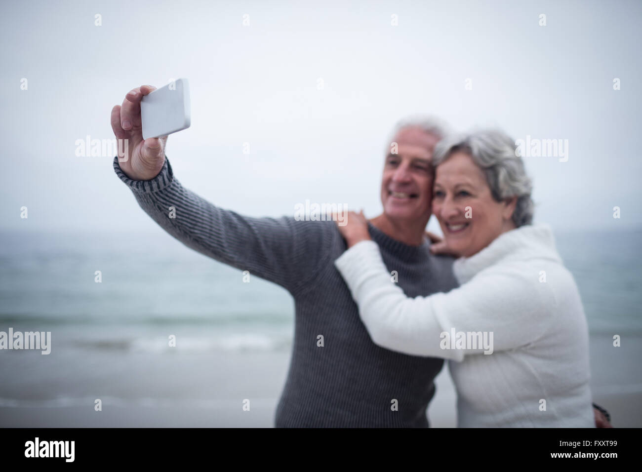 Senior couple taking a selfie on the beach Stock Photo
