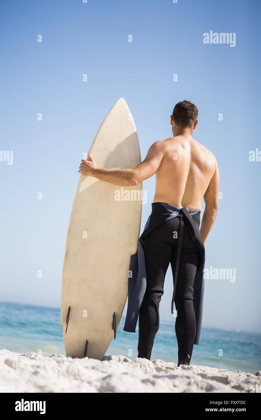 Handsome man holding surfboard Stock Photo - Alamy