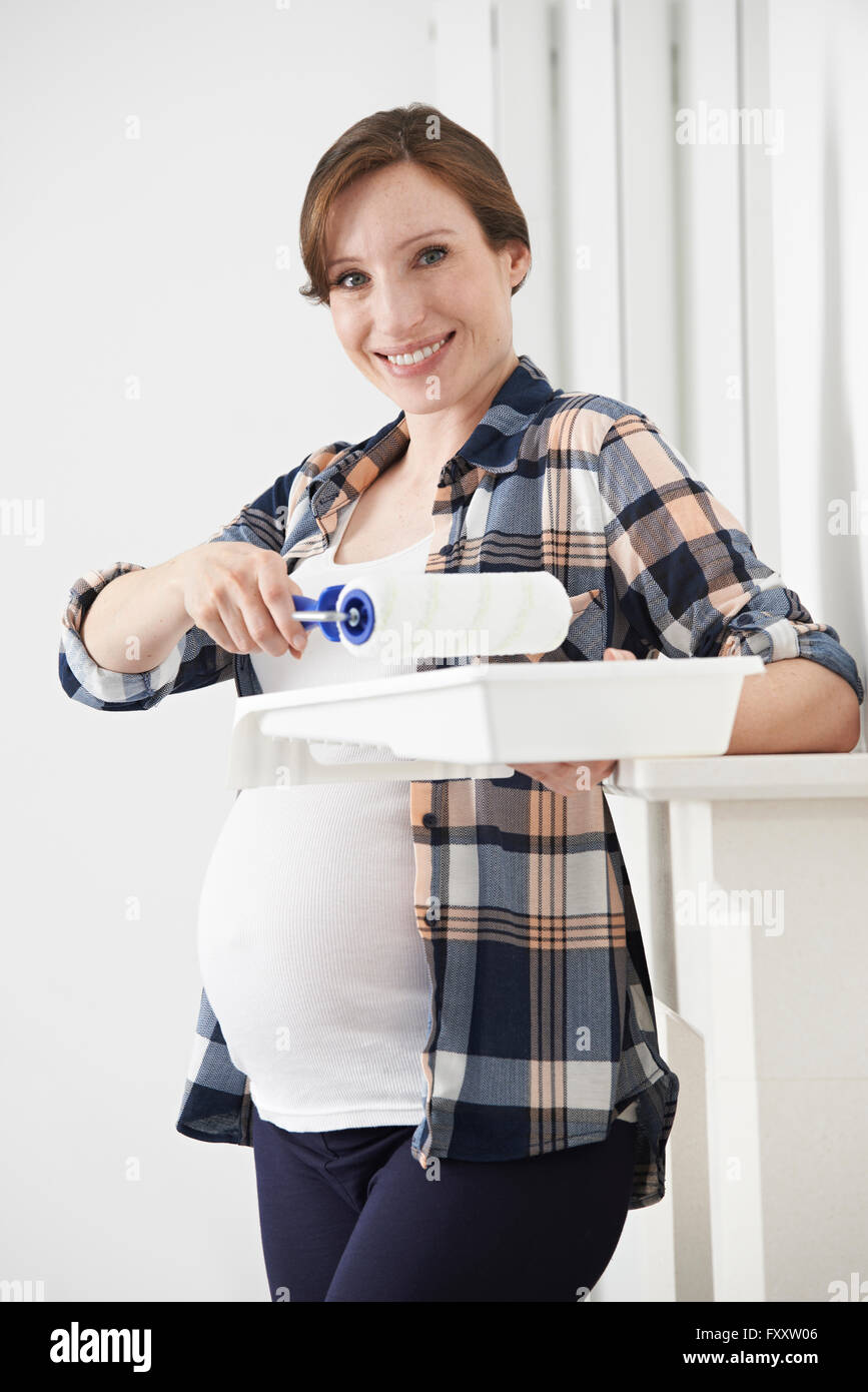 Portrait Of Pregnant Woman Decorating Nursery Stock Photo Alamy