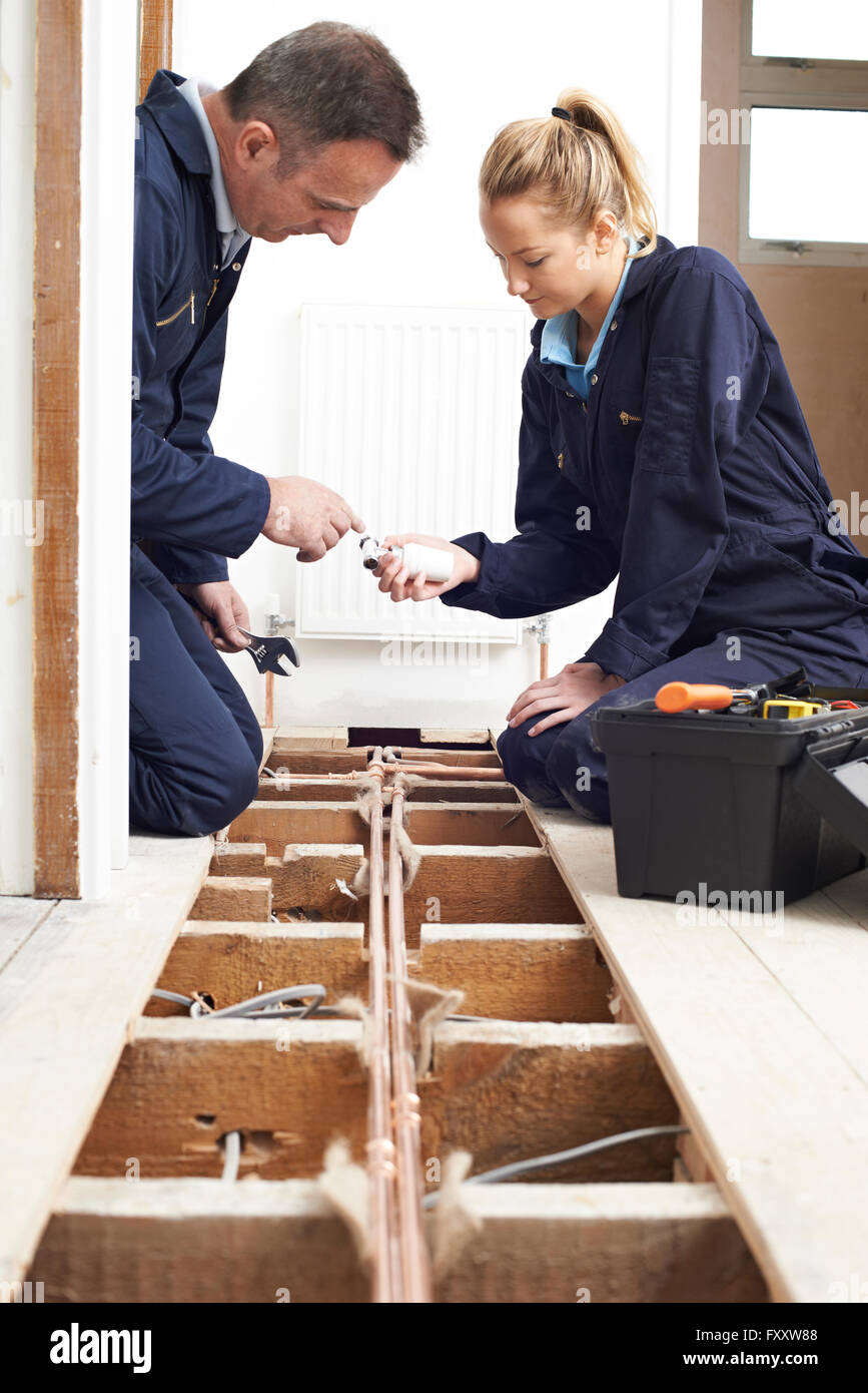 Plumber And Apprentice Fitting Central Heating Stock Photo Alamy