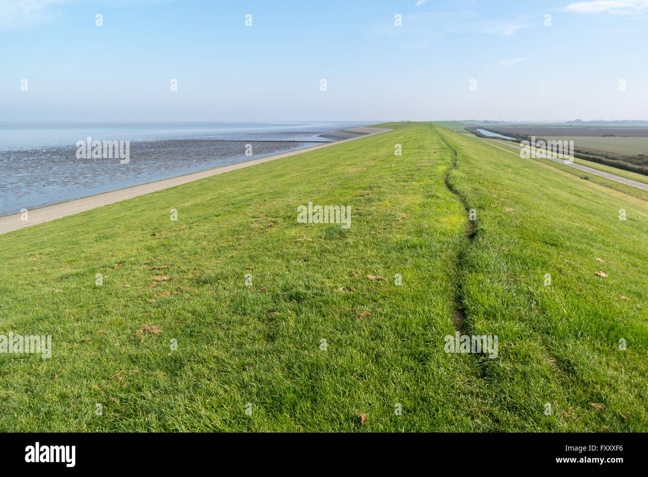 Sea dyke between Frisian polders and Wadden Sea - coastline of Friesland, Netherlands Stock Photo