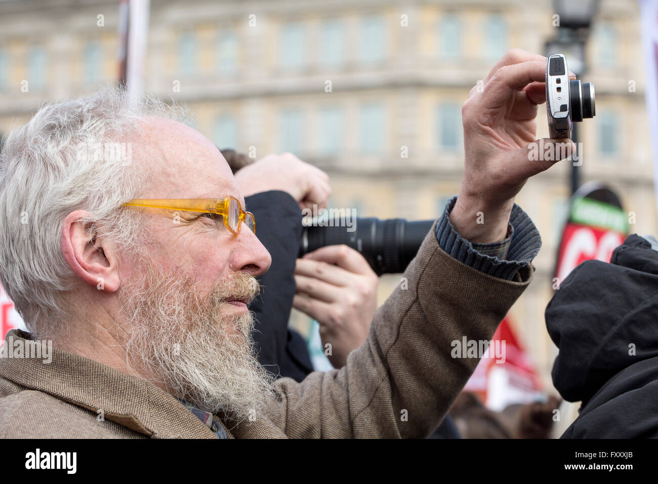 Two cameras at the anti-austerity rally, being used to document the support for the reason behind the demonstration Stock Photo
