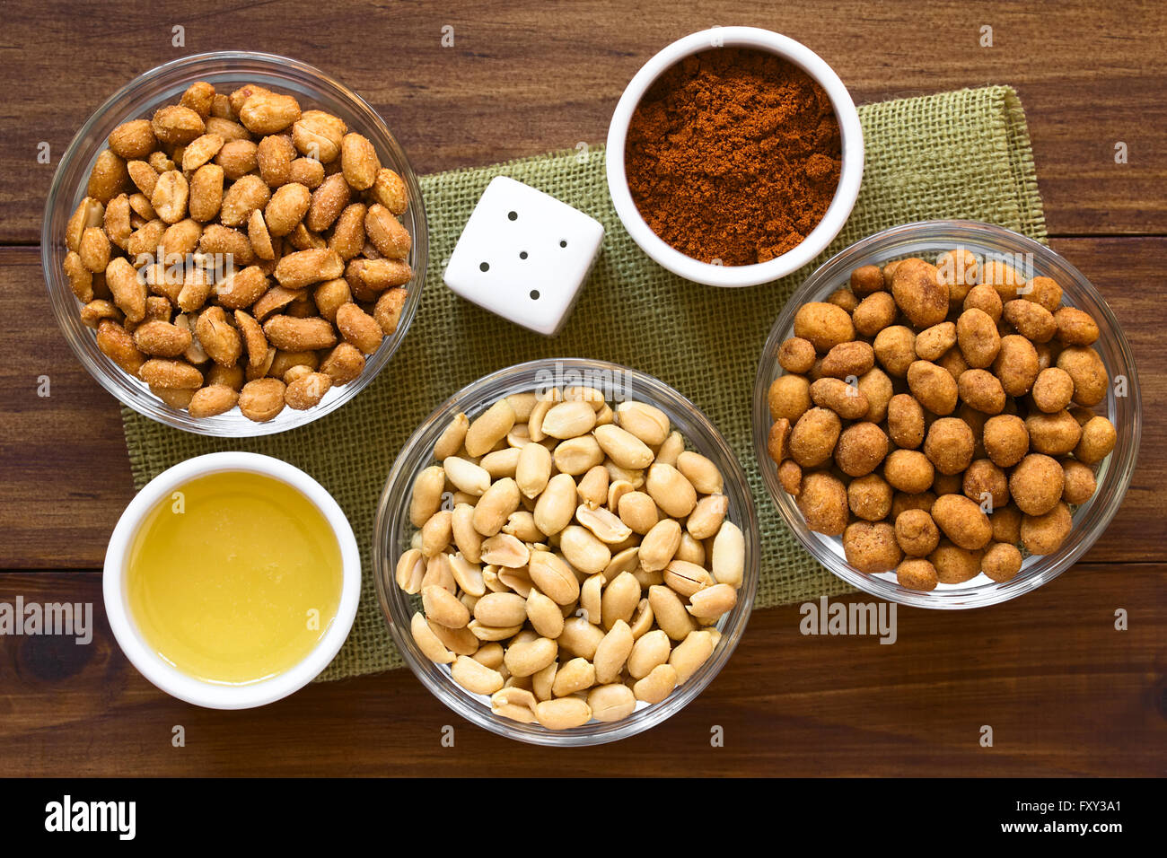 Peanut snacks in glass bowls. Peanuts with honey and salt, salted peanuts, peanuts roasted in a spicy coat Stock Photo