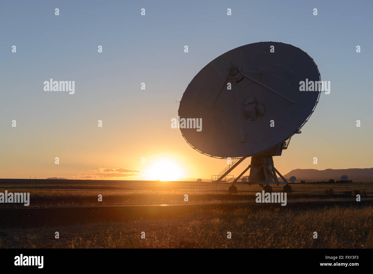 Sunset Huge antenna dish at Very Large Array, searching for imaging signal in space Stock Photo