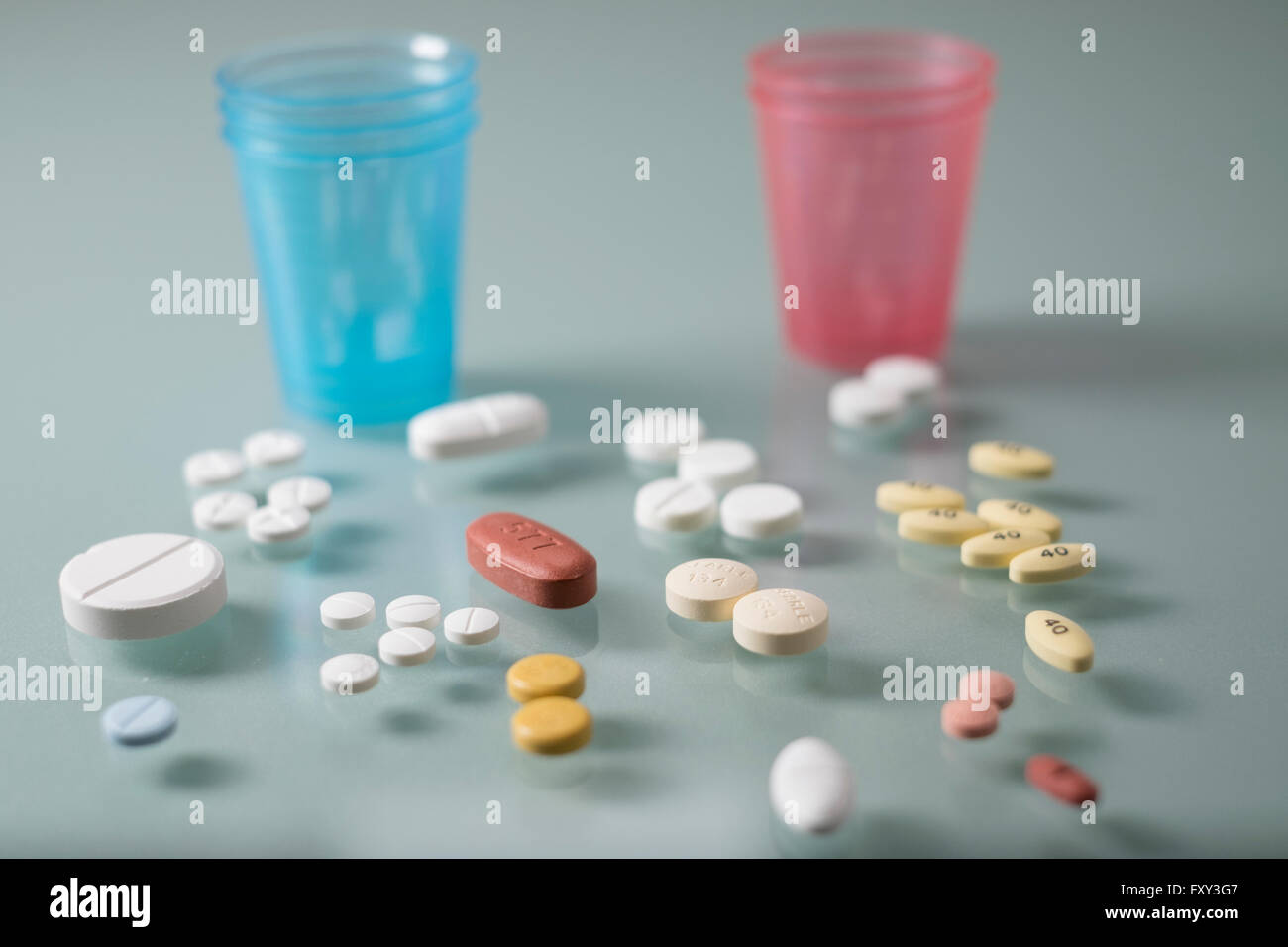 Pills and dispenser cups horizontal Stock Photo