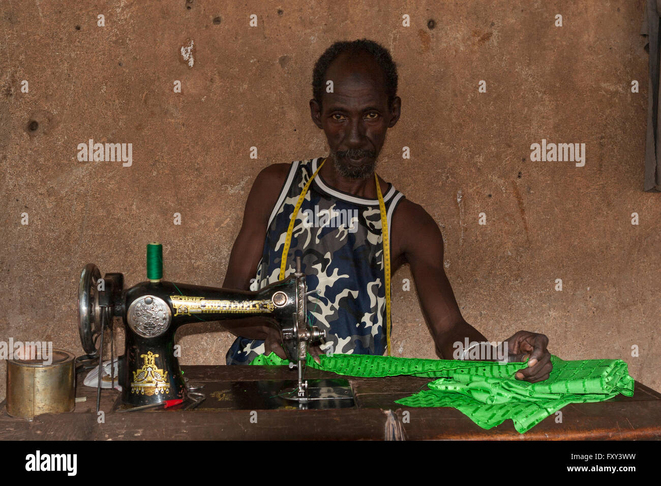 Ghanaian Woman Seamstress Using Hand Operated Sewing