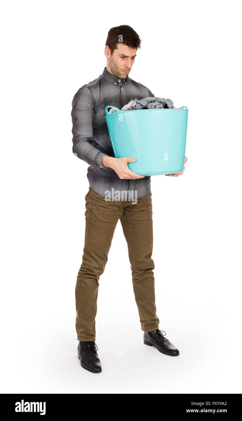 Full length portrait of a young man holding a laundry basket isolated on white background Stock Photo