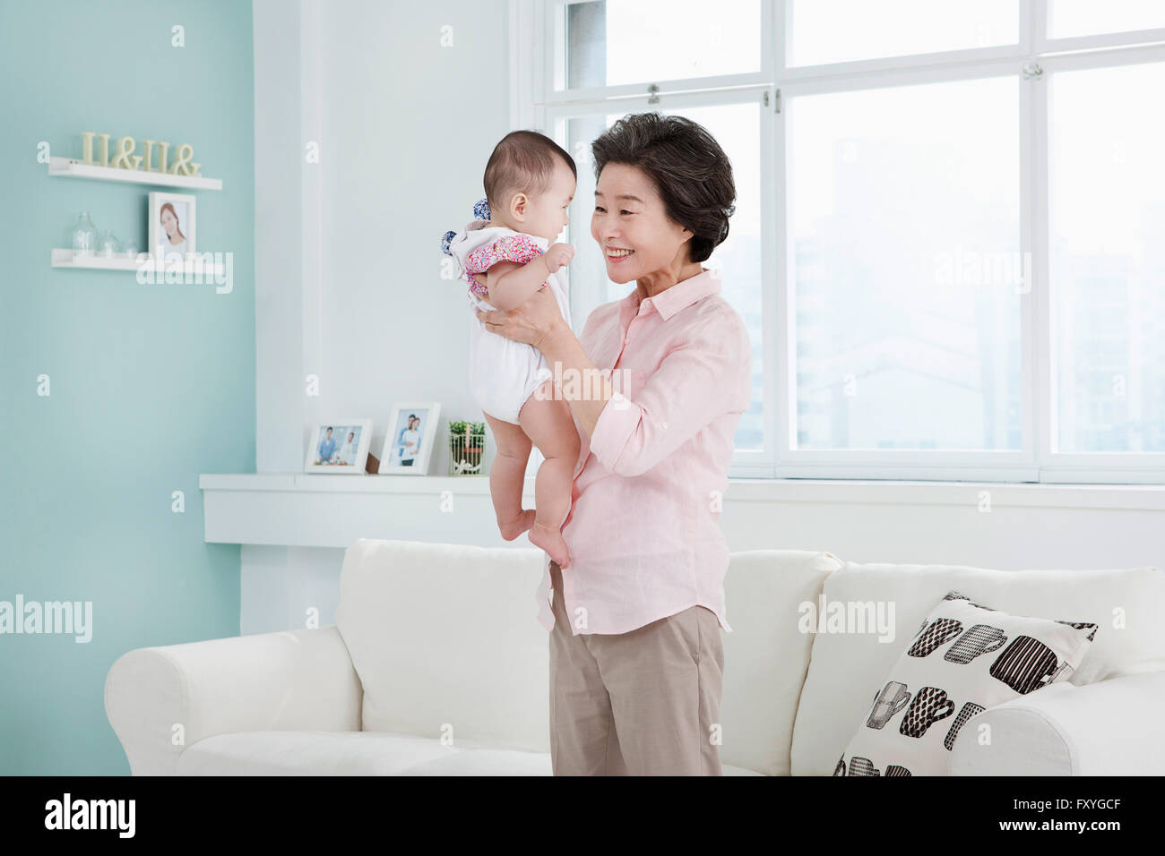 Woman holding her baby hi-res stock photography and images - Alamy