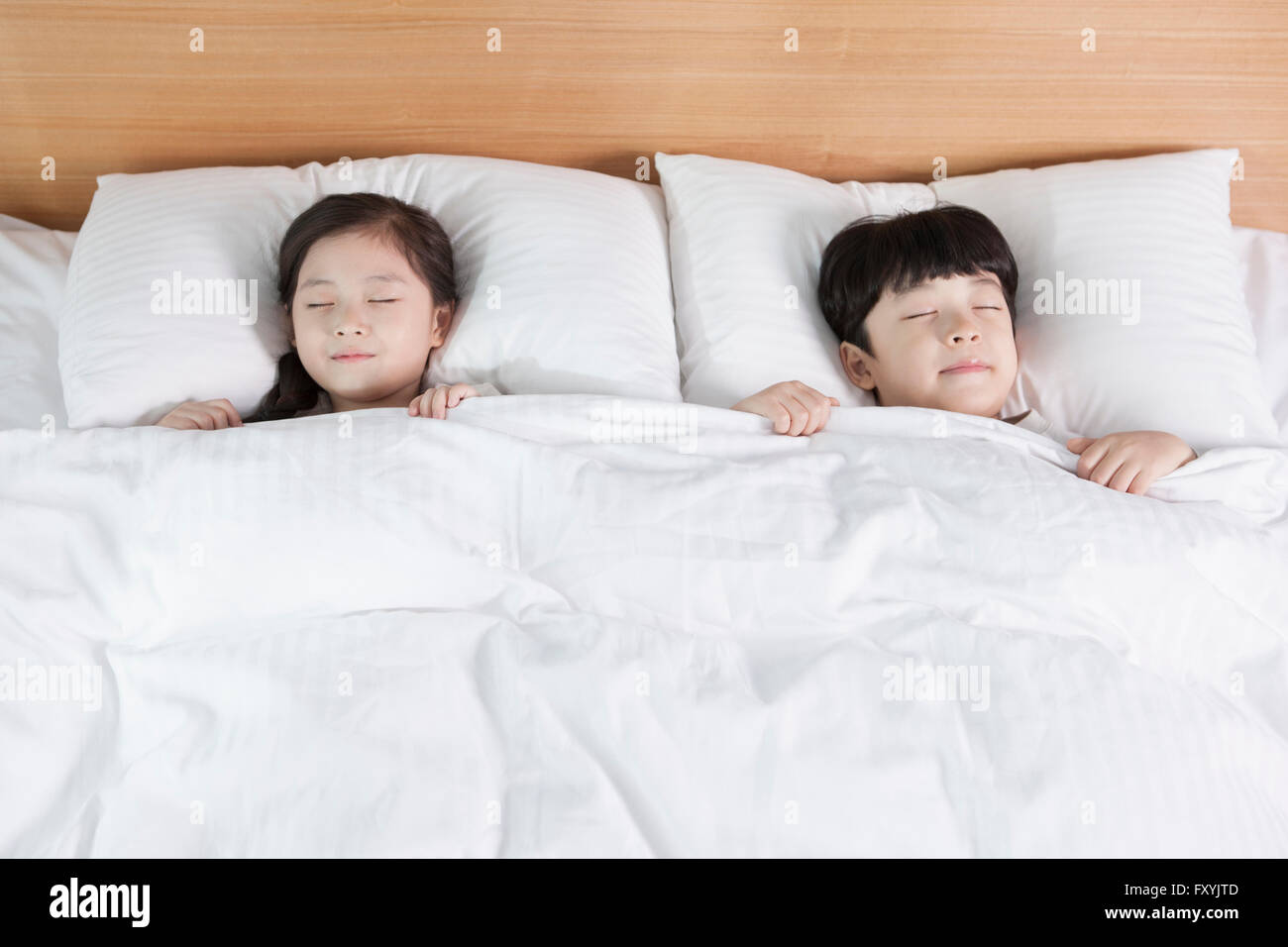 High angle of children in sleep on the bed at the hotel room Stock