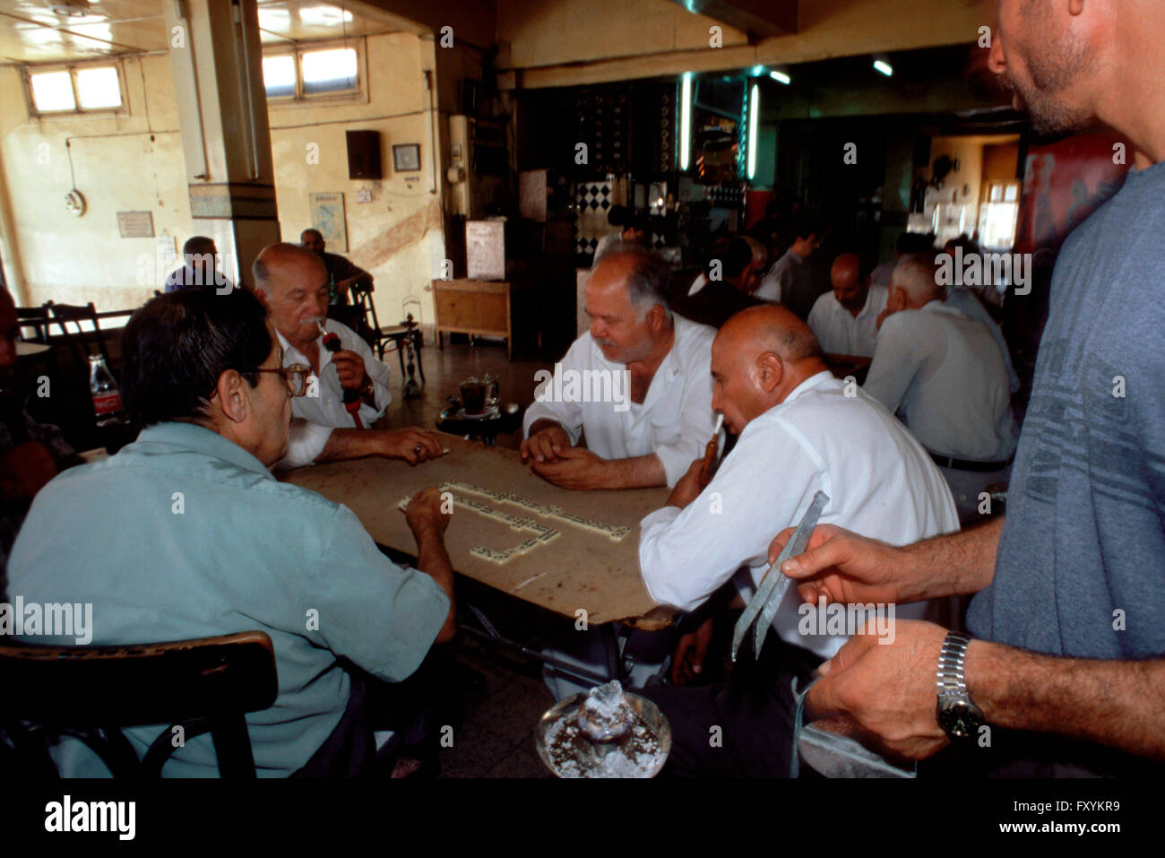 Cafe 'Arab League'. Jordanian Arabs in cafe smoking Nargileh pipes and play domino, Amman, Jordan. Only for men. Stock Photo