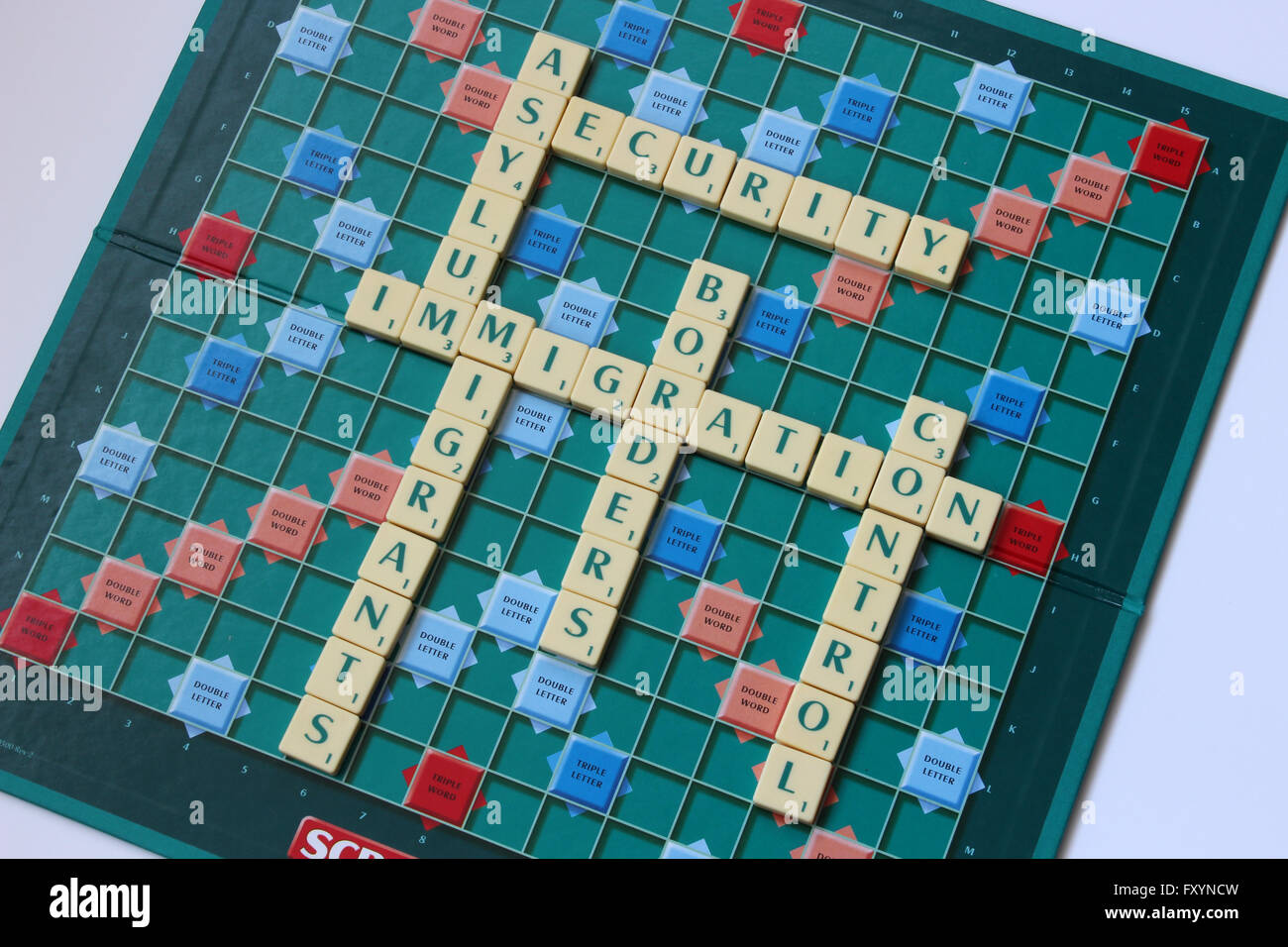 A Scrabble board with words about immigration Stock Photo