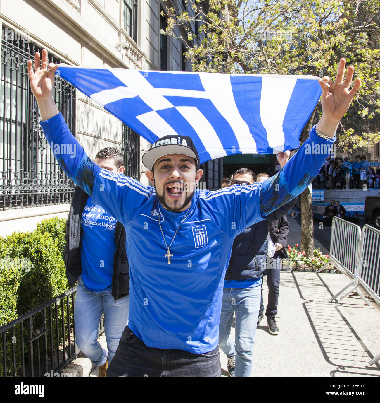 Greek Independence Day Parade, New York City. Proud young man displays the Greek Flag along 5th Ave. in NYC. Stock Photo