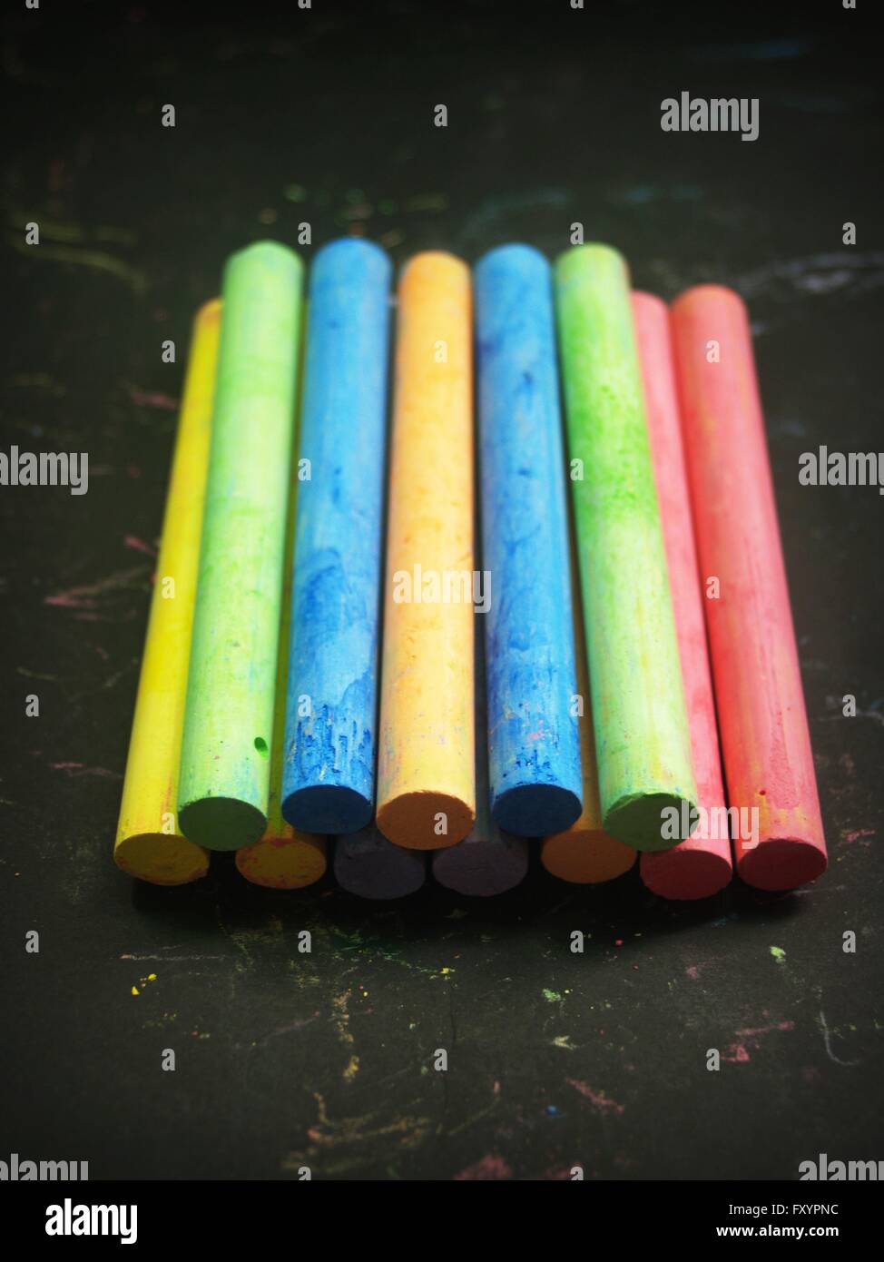 Colored chalk on a blackboard background Stock Photo - Alamy