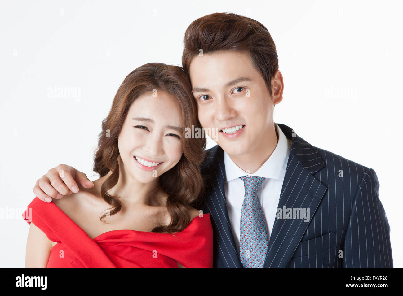 Portrait of young smiling couple staring at front Stock Photo