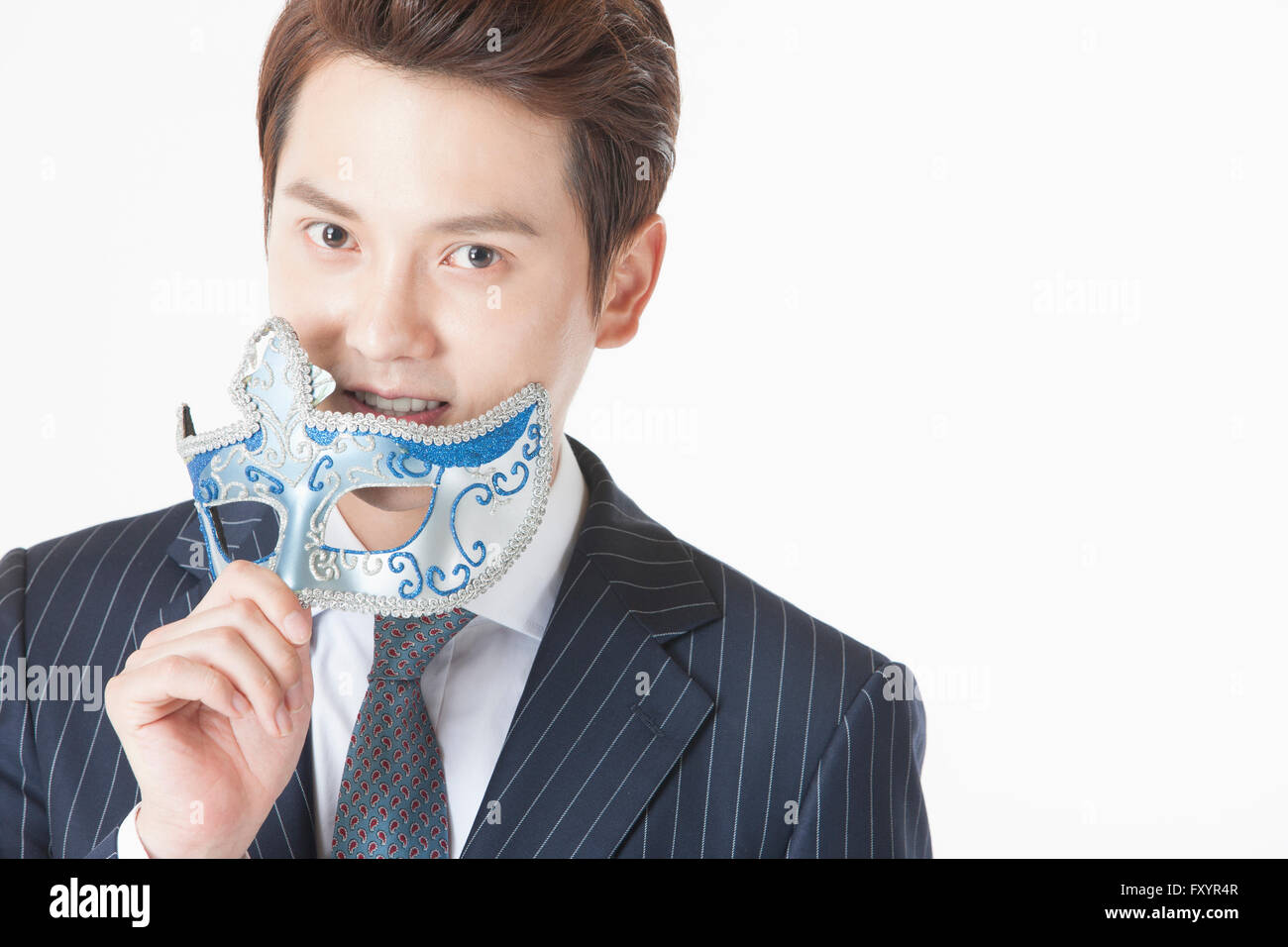 Portrait of young smiling man with a mask staring at front Stock Photo