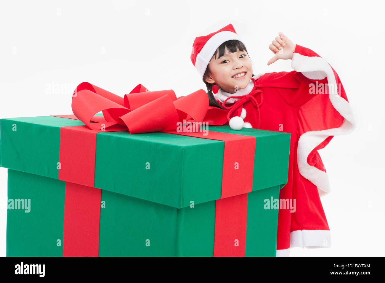 Smiling girl in santa's clothes with a big present box Stock Photo