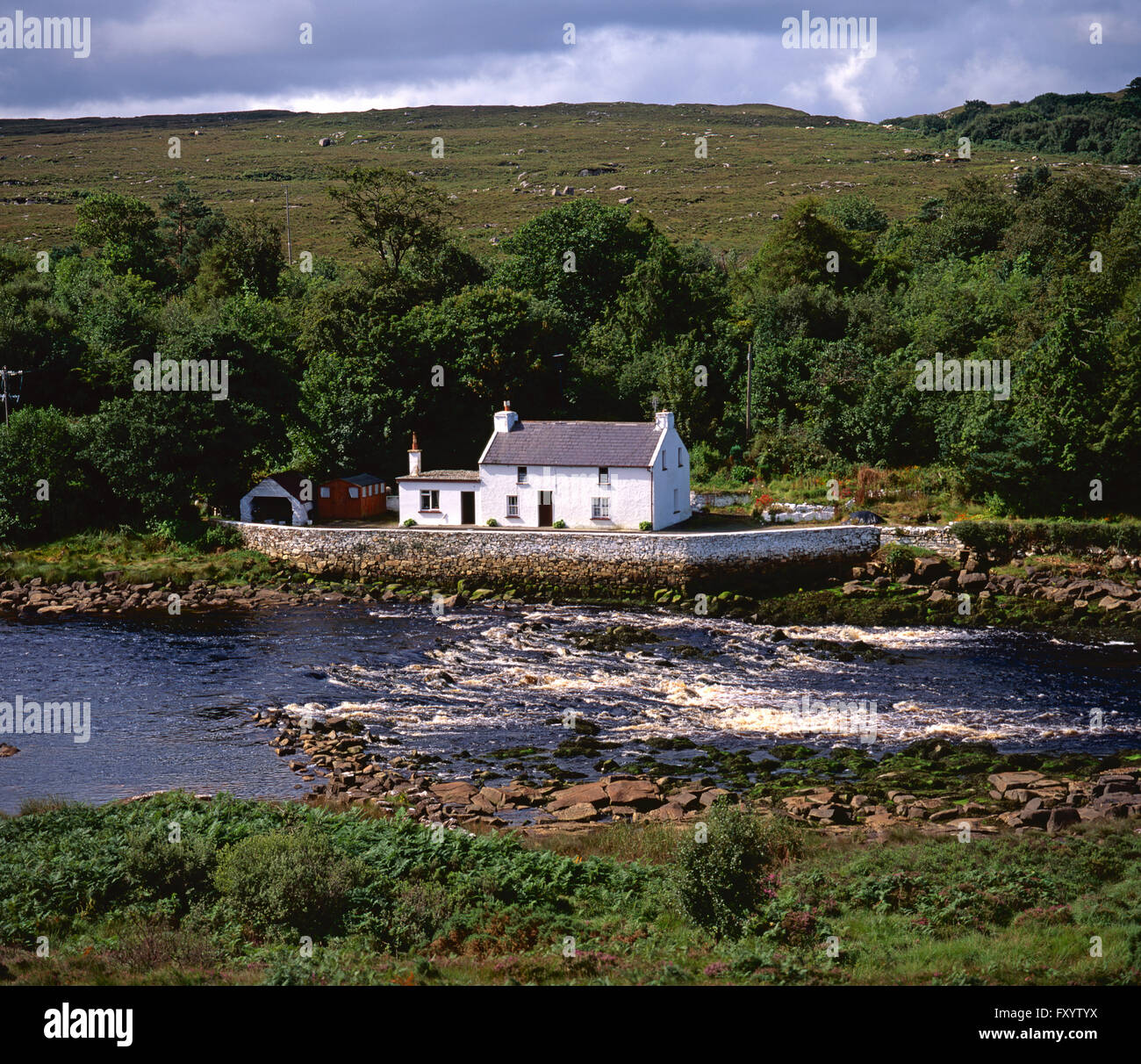 Traditional white cottage on Lackagh River, Creeslough, County Donegal