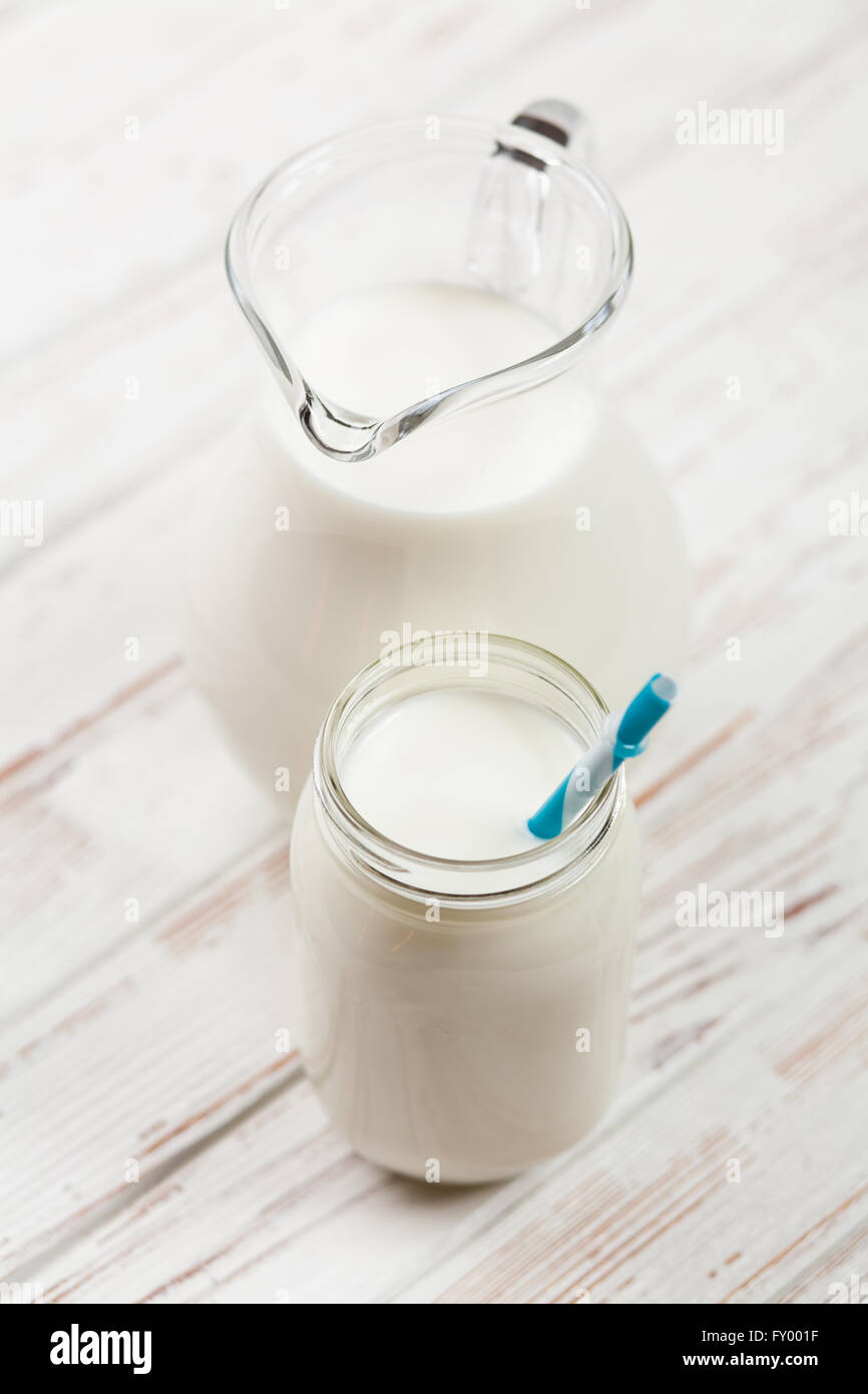 Milk jar on wooden table Stock Photo Alamy