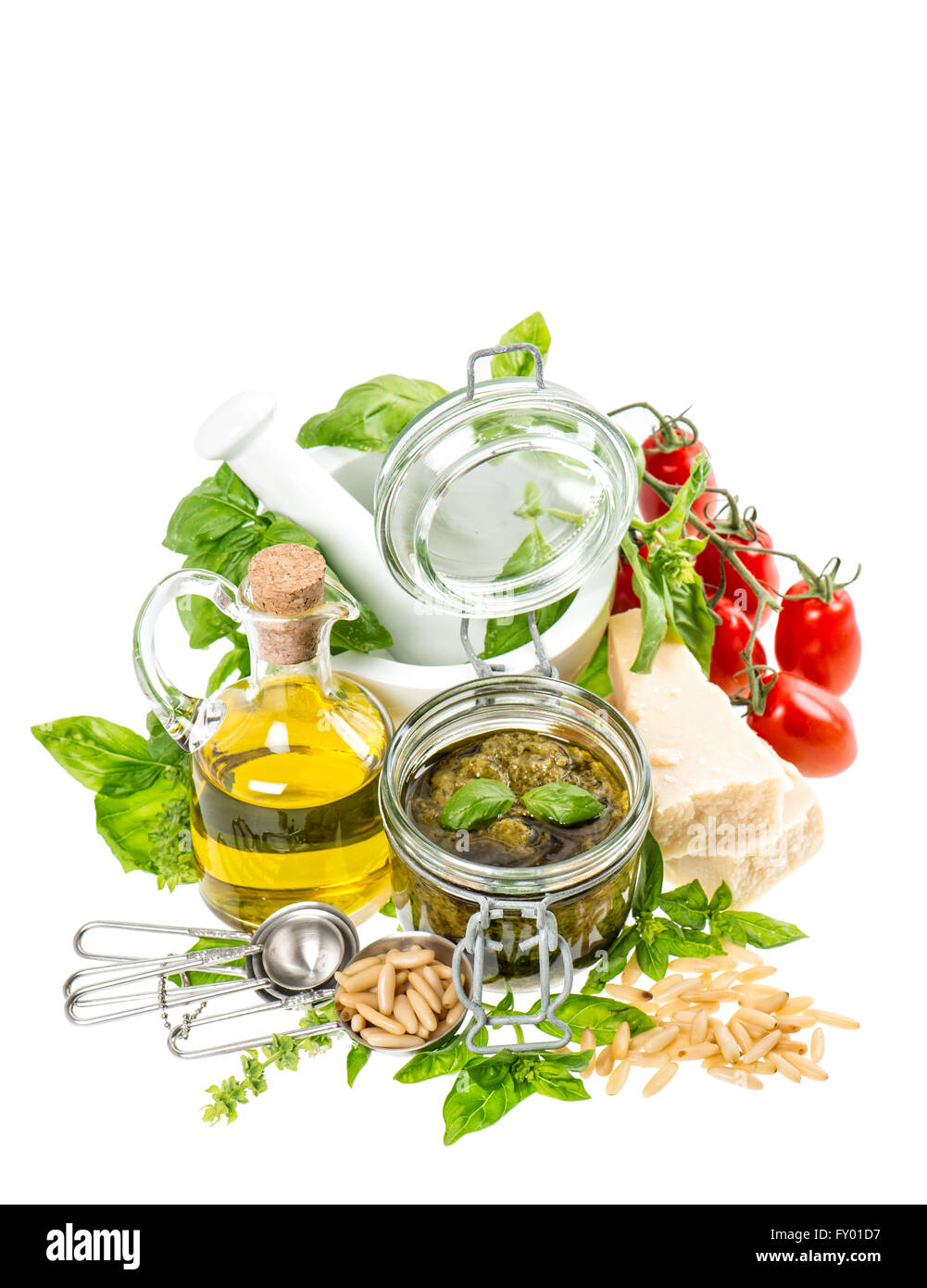 Ingredients for fresh green pesto sauce on white background. Olive oil