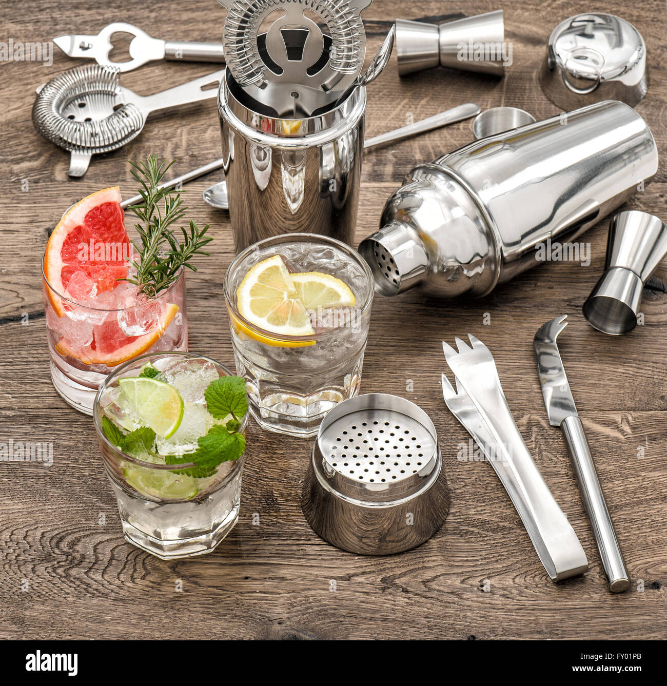 Drinks with ice and tonic water. Cocktail making bar accessories, shaker,  glasses, mint leaves Stock Photo - Alamy
