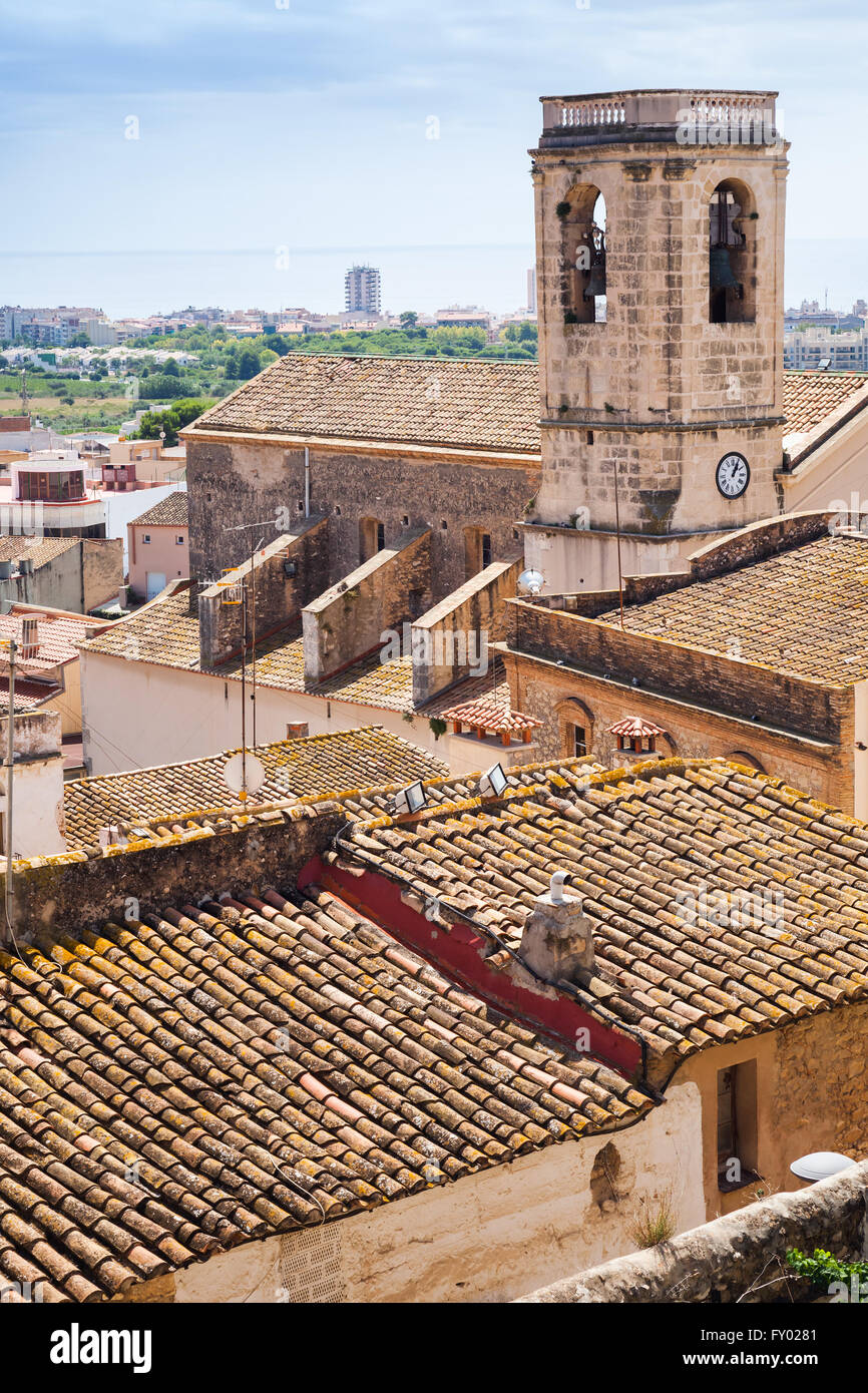 Vertical cityscape of Spanish resort town Calafell in summer. Bell tower and red tiling roofs in old part of town Stock Photo