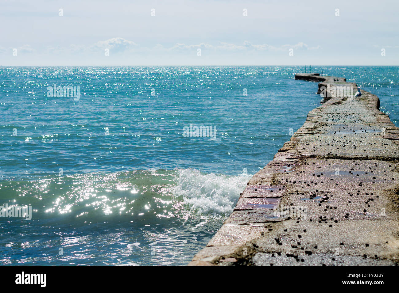 Sea wall at L'Etacq, St. Ouen, Jersey just after high tide on Tuesday 12th April 2016 on a very hot, sunny day. Stock Photo