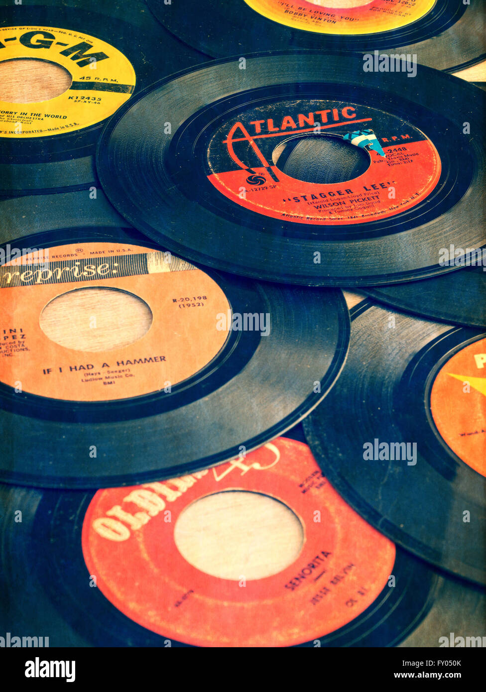Old vinyl 45s from the early days of Rock and Roll music. Stock Photo
