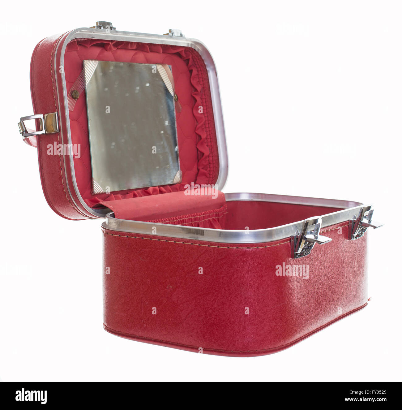 An old vintage red train case or makeup luggage isolated over white background Stock Photo