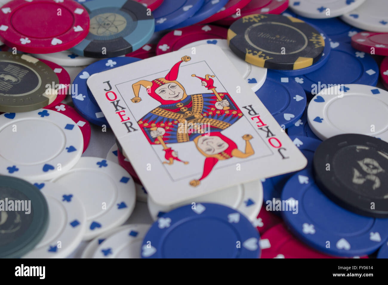 Close up of poker chips with Joker on top Stock Photo - Alamy