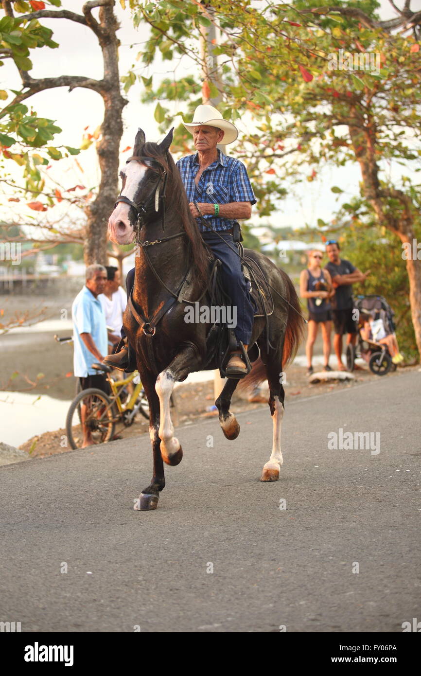 Man riding horse Western style on street Stock Photo