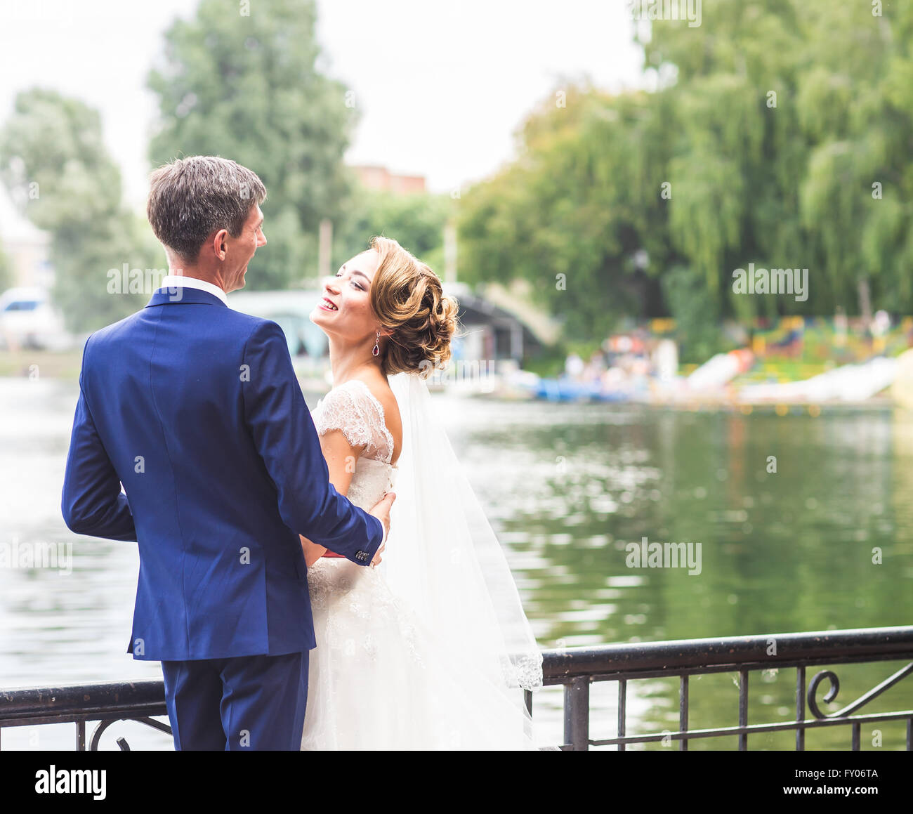 Beautiful bride and groom embracing on their wedding day outdoors Stock ...
