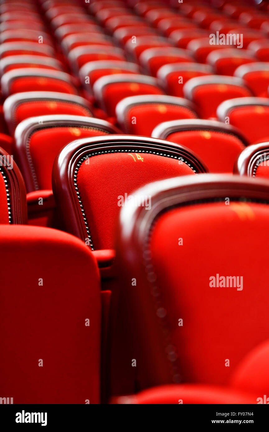 Rows of empty red velvet seats inside a theater Stock Photo - Alamy