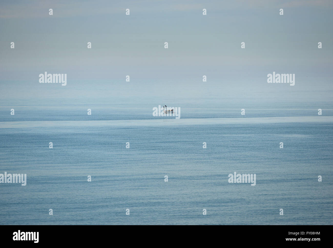 Tiny inshore fishing boat in open water. Sussex, UK Stock Photo