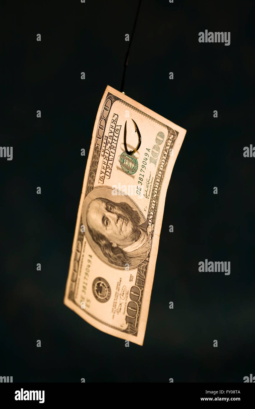 A 100 dollar bill hanging on a fishing hook sharp focus on hook coming through paper on dark blue background Stock Photo - Alamy A 100 dollar bill hanging on a fishing hook sharp focus on hook coming through paper on dark blue background Stock Photo - Alamy