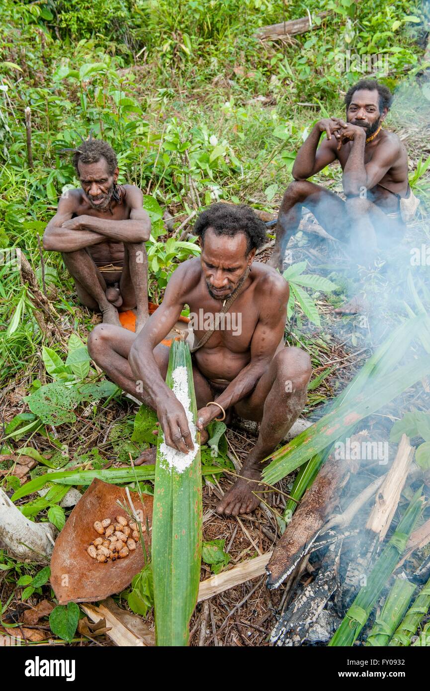 Korowai man it suggests cooked sago worms. Stock Photo