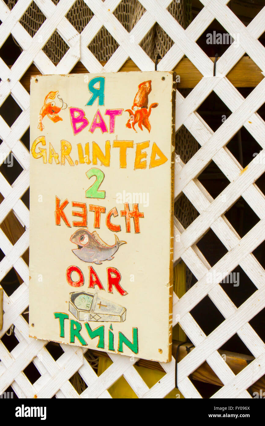 Fulton, TX, USA - April 12, 2016 :  Funny sign at fishing marina.  Bait Guaranteed to Catch Fish or Die Trying in illustrations. Stock Photo