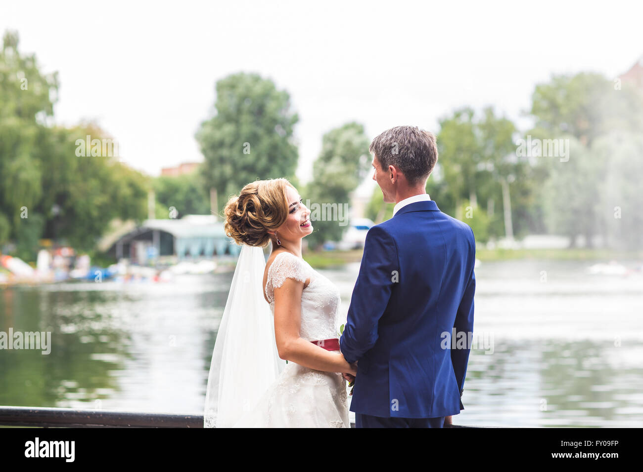 wedding theme, holding hands newlyweds Stock Photo - Alamy