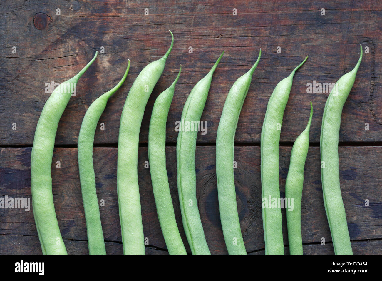 Background made from lot of freshness green beanstalk on wooden board Stock Photo