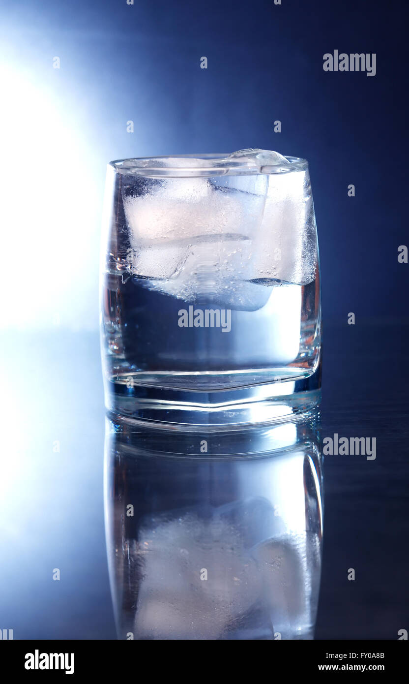 Glass of water with ice cubes on nice dark background Stock Photo - Alamy